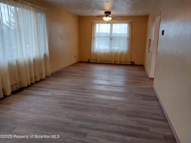 empty room with light hardwood / wood-style flooring and ceiling fan