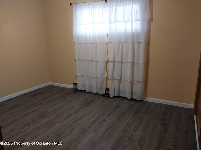 unfurnished room with dark hardwood / wood-style floors