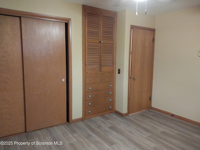 unfurnished bedroom featuring light wood-type flooring