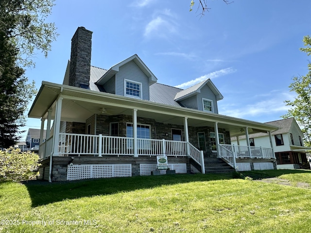 185 Southpoint Rd, Montrose, PA 18801 - farmhouse-style home with stone siding, covered porch, a front yard, and a chimney