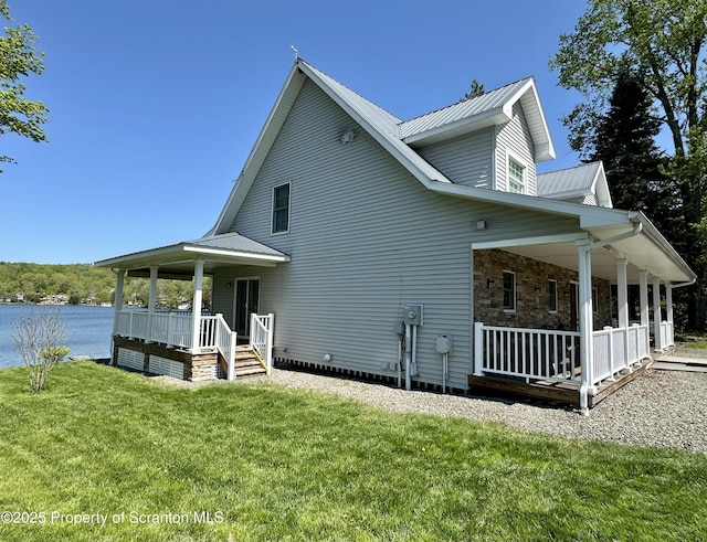 185 Southpoint Rd, Montrose, PA 18801 - view of side of home featuring a porch, a yard, metal roof, and a water view