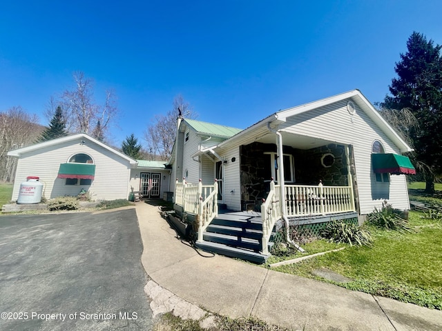 4886 State Route 11, Hop Bottom, PA 18824 - view of front of home featuring metal roof, driveway, and covered porch