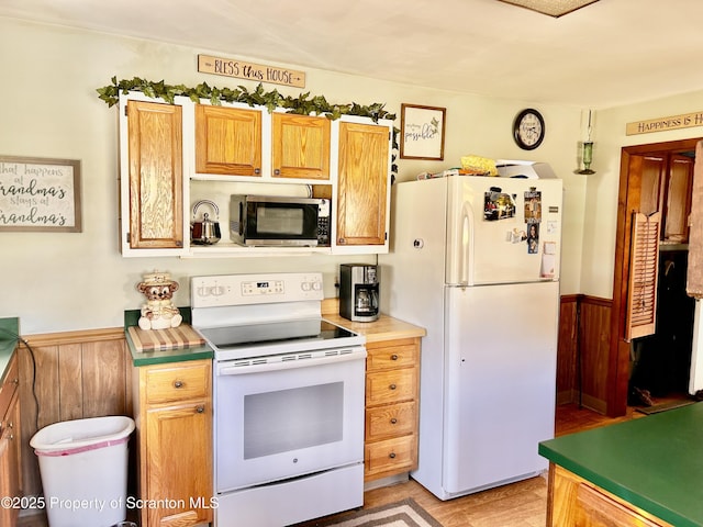 4886 State Route 11, Hop Bottom, PA 18824 - kitchen featuring light wood-type flooring, white appliances, and a wainscoted wall