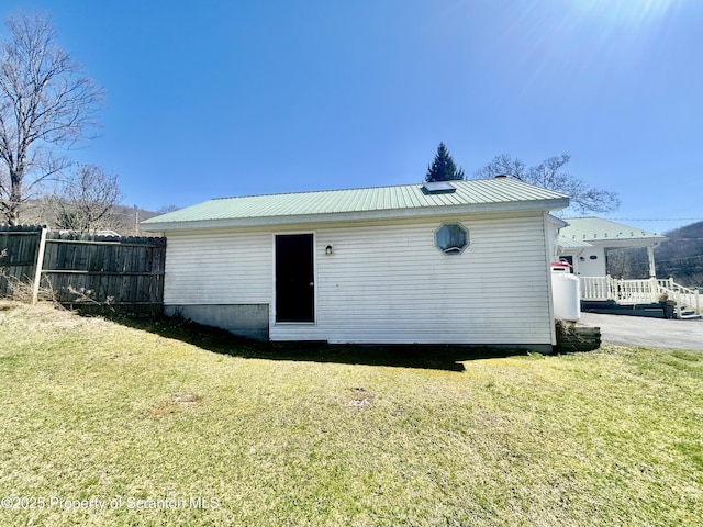 4886 State Route 11, Hop Bottom, PA 18824 - rear view of property featuring metal roof, fence, and a lawn