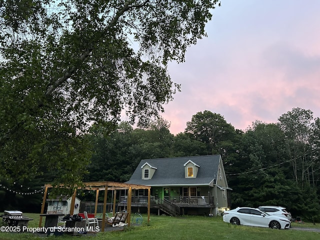 view of front of property featuring a yard and covered porch