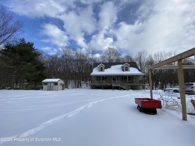 farmhouse featuring a porch and a shed