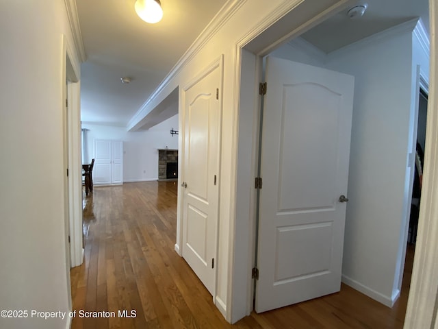 corridor featuring hardwood / wood-style flooring and crown molding