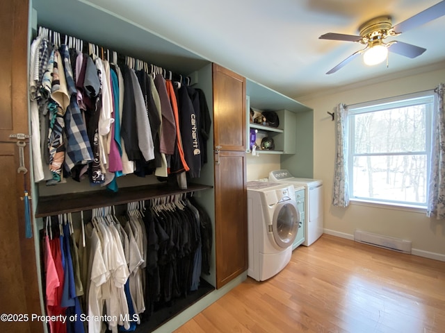 laundry area with cabinets, light hardwood / wood-style flooring, ornamental molding, ceiling fan, and washer and clothes dryer