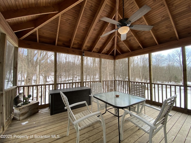 unfurnished sunroom featuring ceiling fan, vaulted ceiling with beams, and wood ceiling