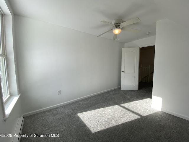 carpeted empty room with a baseboard radiator