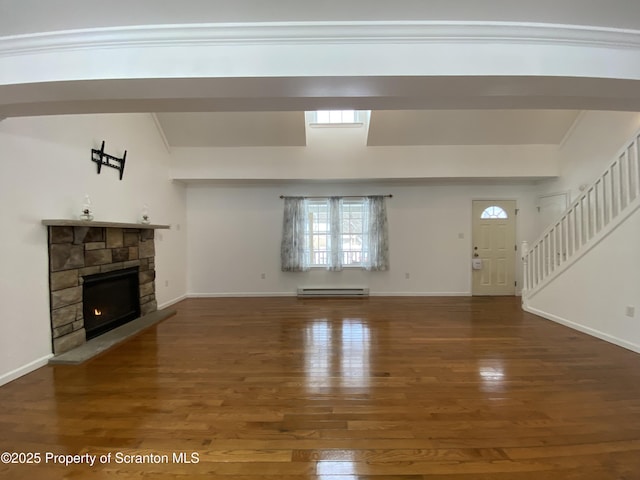 unfurnished living room featuring dark hardwood / wood-style floors, a stone fireplace, crown molding, and a baseboard heating unit