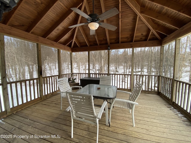 unfurnished sunroom with lofted ceiling with beams, wooden ceiling, and ceiling fan