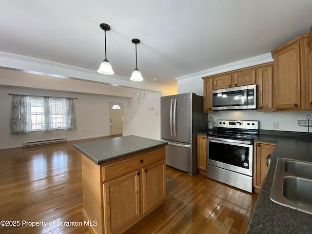 kitchen featuring a kitchen island, appliances with stainless steel finishes, pendant lighting, a baseboard radiator, and sink