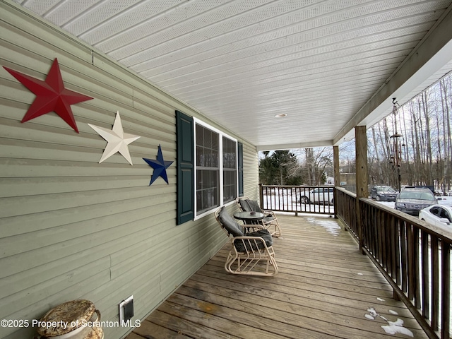 wooden terrace with a porch