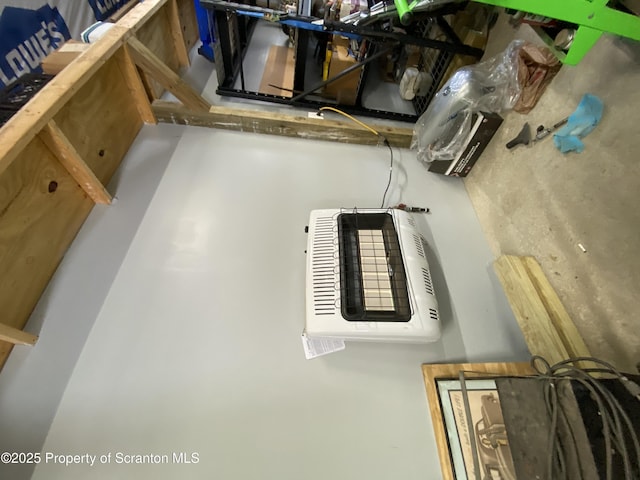 interior space featuring heating unit and concrete floors