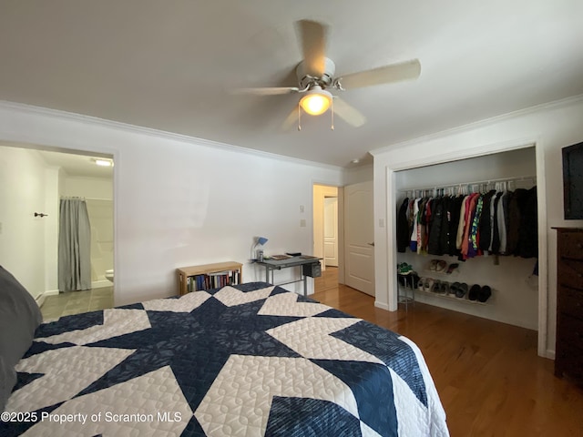 bedroom with light hardwood / wood-style flooring, ceiling fan, connected bathroom, ornamental molding, and a closet