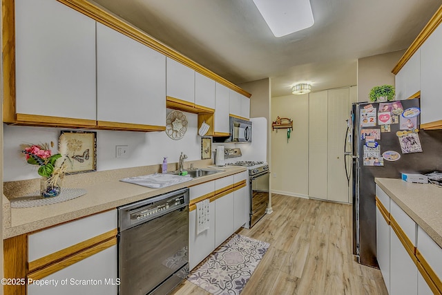 1504 Summit Pt Unit 1504, Scranton, PA 18508 - kitchen with black appliances, light countertops, light wood-style flooring, and white cabinetry
