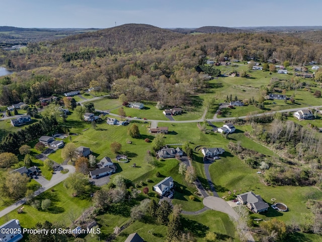 birds eye view of property featuring a wooded view