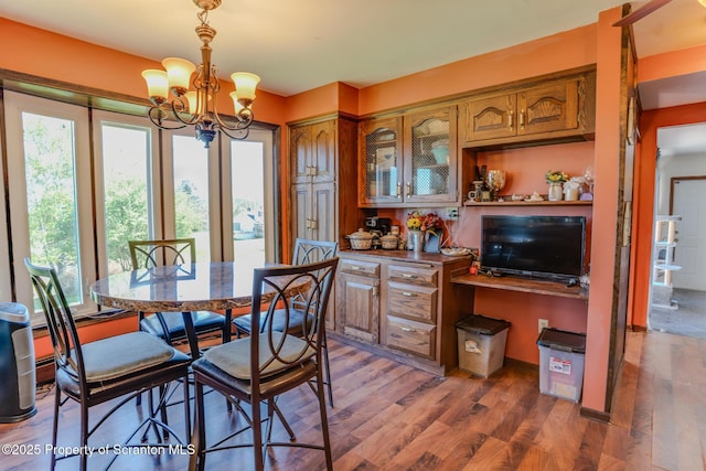dining area with an inviting chandelier and wood finished floors