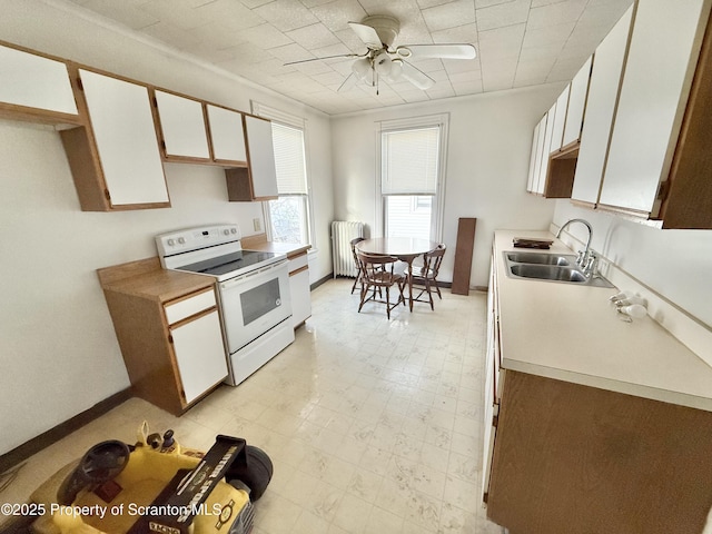 kitchen featuring radiator, white cabinets, white range with electric cooktop, and light countertops