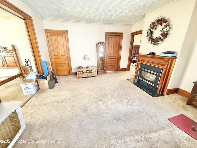 living room with baseboards, ornamental molding, a fireplace with flush hearth, and light colored carpet