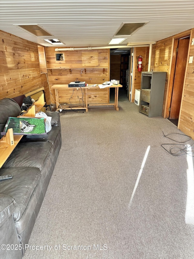 carpeted living room with wooden walls