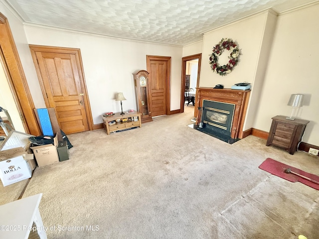 living room with baseboards, a fireplace with flush hearth, ornamental molding, a textured ceiling, and carpet flooring