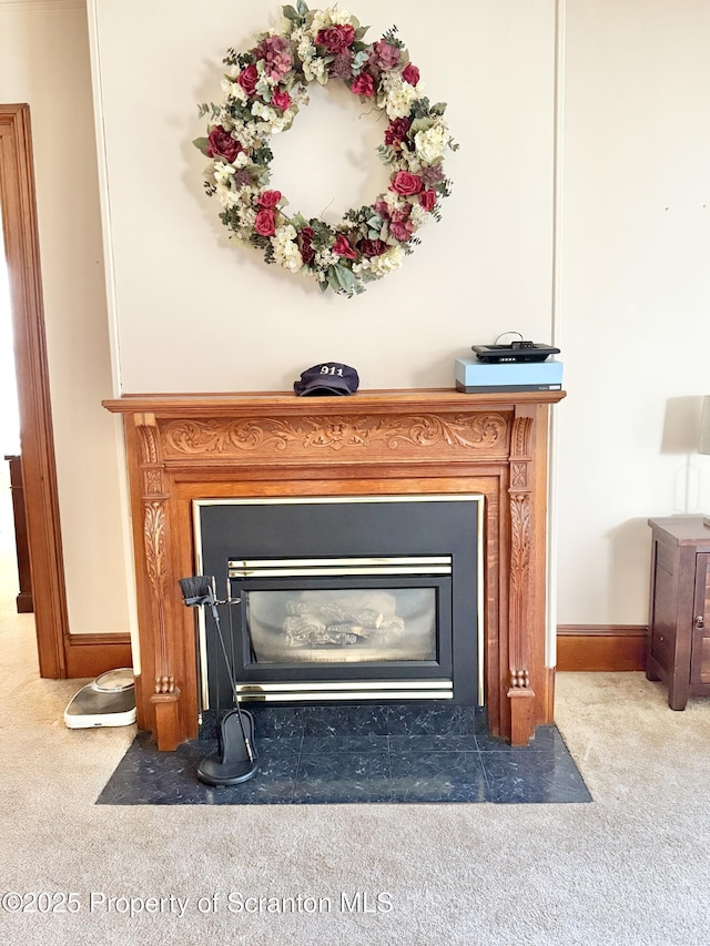 room details featuring carpet floors, a fireplace with flush hearth, and baseboards