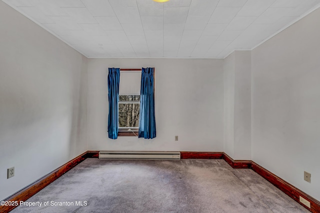 unfurnished room with a baseboard radiator and carpet floors