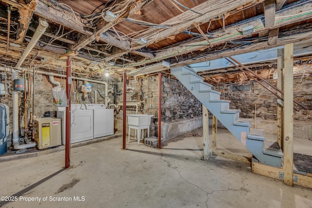 basement with sink and washer and dryer