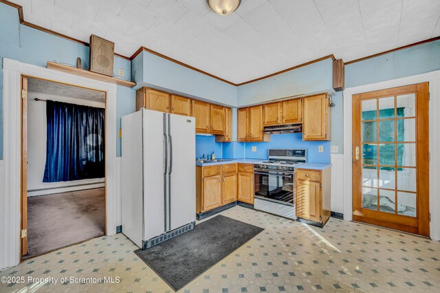 kitchen featuring a baseboard heating unit, ornamental molding, gas range oven, and white refrigerator