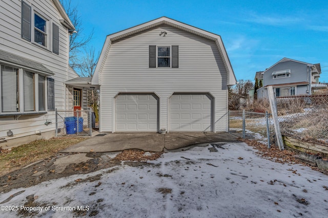 view of snow covered exterior with a garage