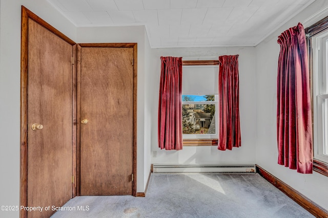 unfurnished bedroom featuring a baseboard radiator and light carpet