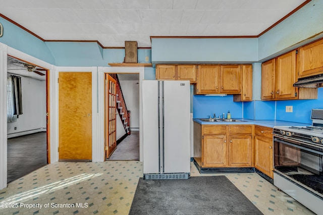 kitchen featuring sink, range with gas cooktop, white refrigerator, baseboard heating, and ornamental molding