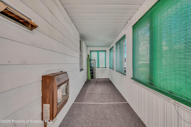 hallway with carpet and heating unit