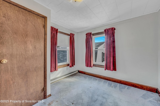 spare room featuring carpet floors and baseboard heating