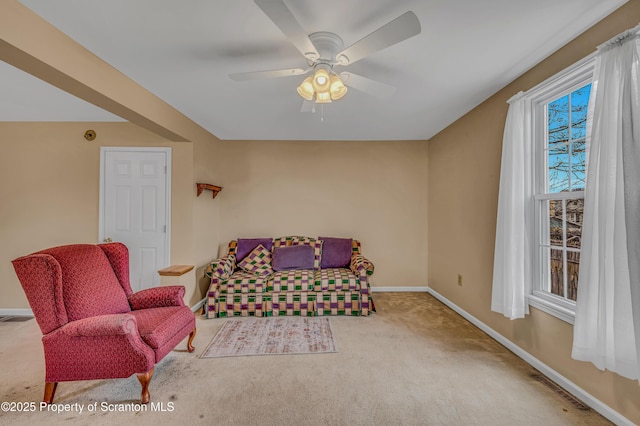 sitting room with visible vents, baseboards, carpet floors, and a ceiling fan