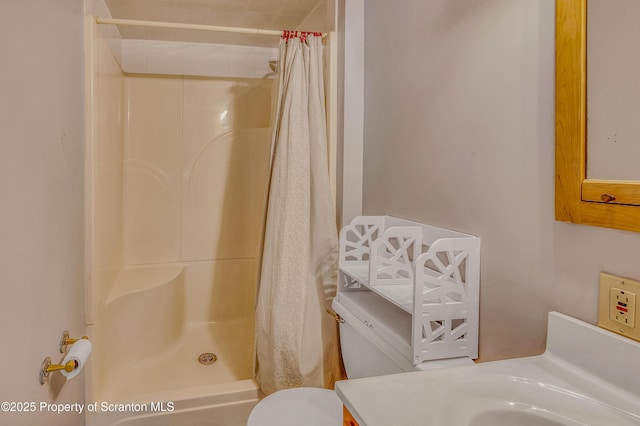 bathroom featuring vanity, toilet, and a shower stall