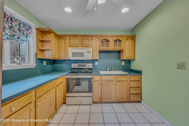 kitchen with light tile patterned floors, white microwave, open shelves, electric range, and a sink