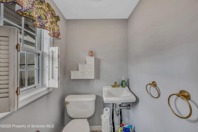 bathroom featuring a wealth of natural light and toilet