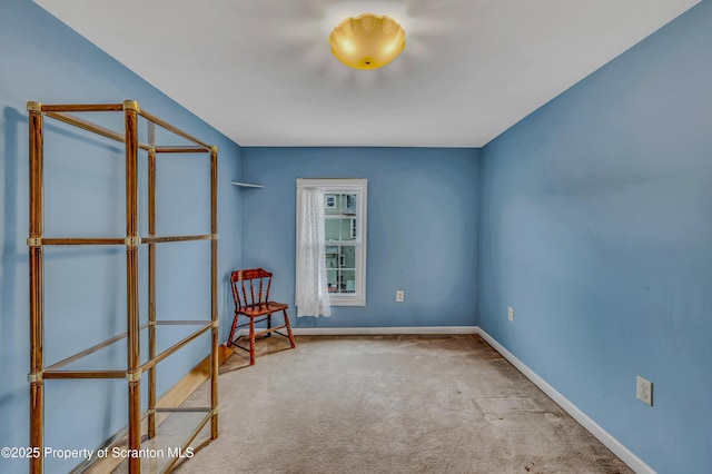 empty room with baseboards and carpet