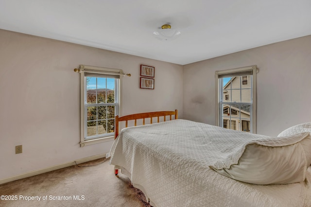 carpeted bedroom featuring baseboards