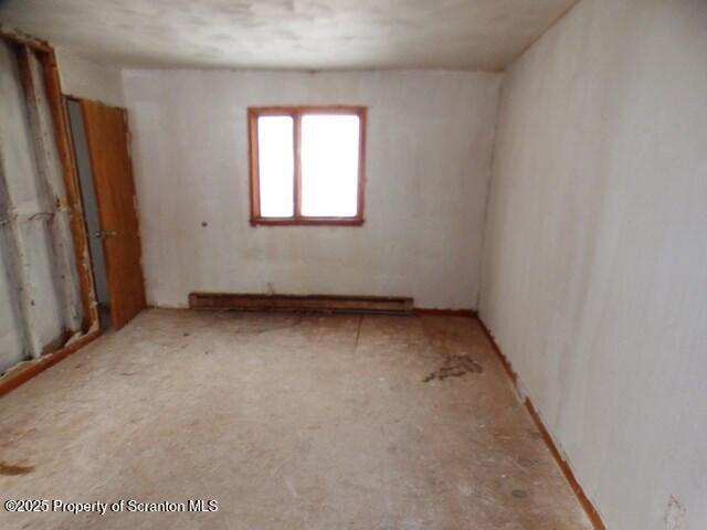 unfurnished room featuring a baseboard radiator