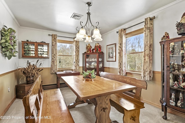 dining area with a baseboard heating unit, ornamental molding, visible vents, and a notable chandelier