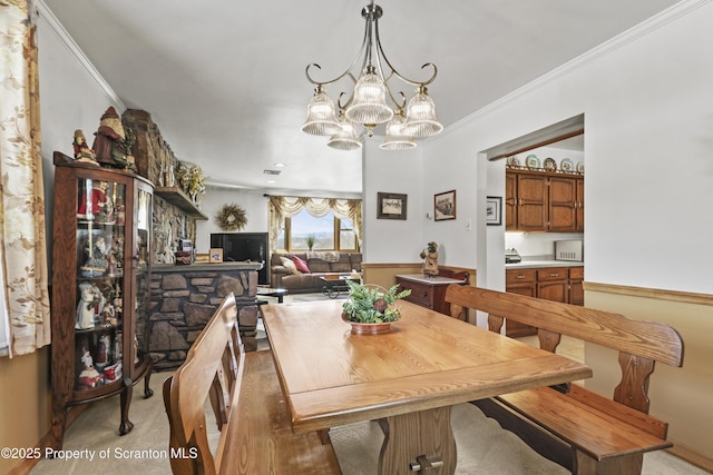 dining space with ornamental molding, visible vents, and an inviting chandelier