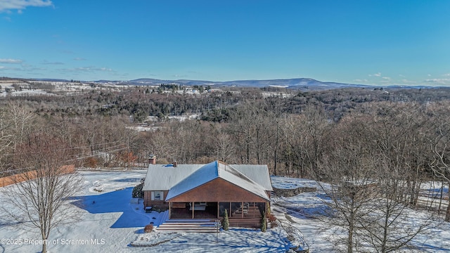 snowy aerial view with a mountain view