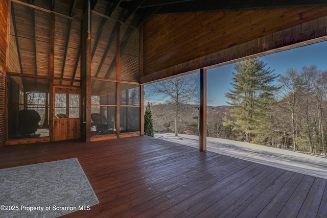 unfurnished sunroom with vaulted ceiling and a mountain view