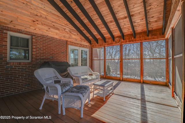 unfurnished sunroom with lofted ceiling with beams and wooden ceiling