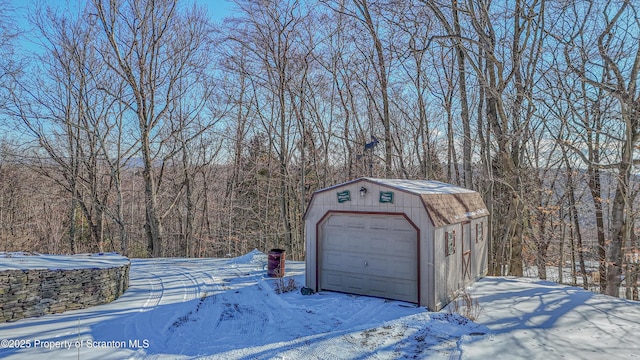 snow covered garage with a garage