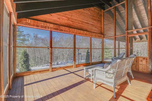 unfurnished sunroom featuring lofted ceiling